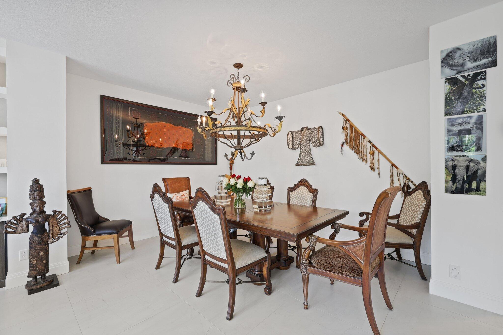 5530 Northeast Trieste Terrace, Unit 5530 Boca Raton, FL 33487 - Photo 38 of 57 a view of a dining room with furniture and chandelier