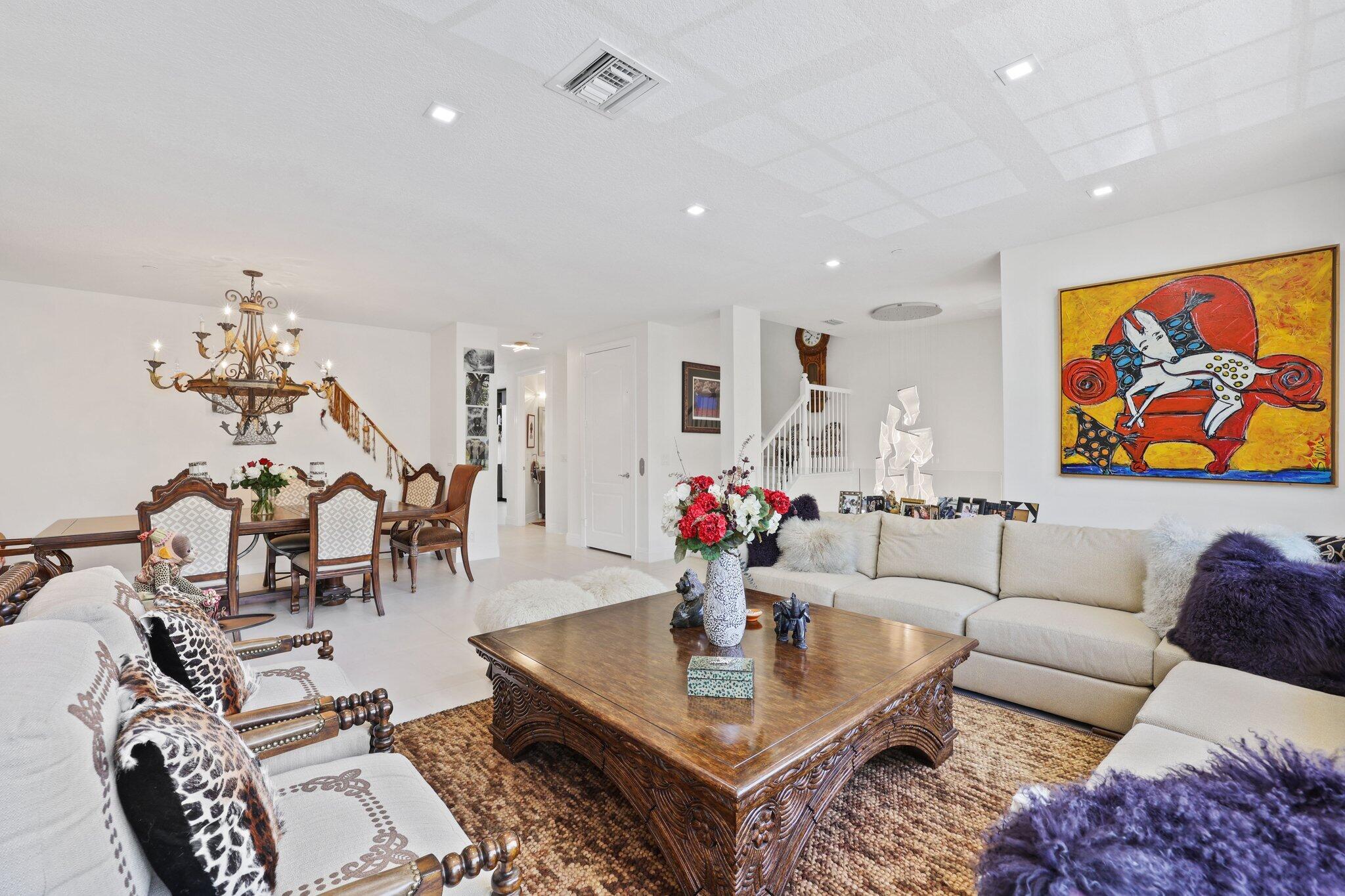 5530 Northeast Trieste Terrace, Unit 5530 Boca Raton, FL 33487 - Photo 39 of 57 a living room with furniture and painting on the wall