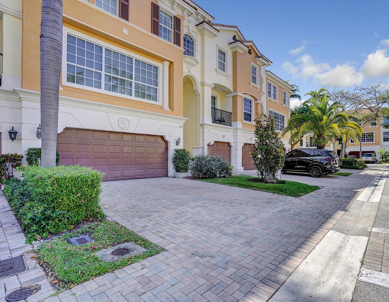 5530 Northeast Trieste Terrace, Unit 5530 Boca Raton, FL 33487 - Photo 4 of 57 a view of a parked cars in front of a building