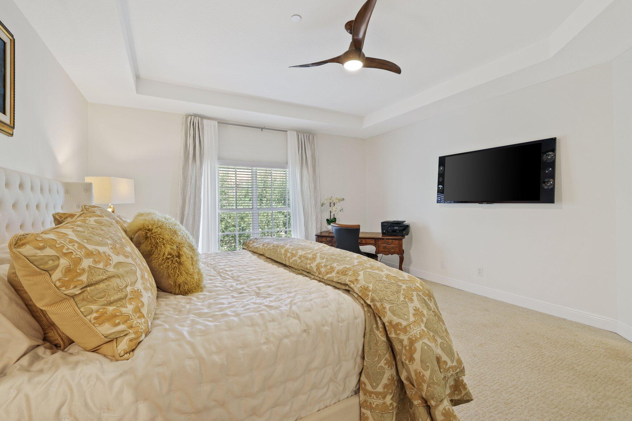 5530 Northeast Trieste Terrace, Unit 5530 Boca Raton, FL 33487 - Photo 43 of 57 a bedroom with a bed and a flat screen tv