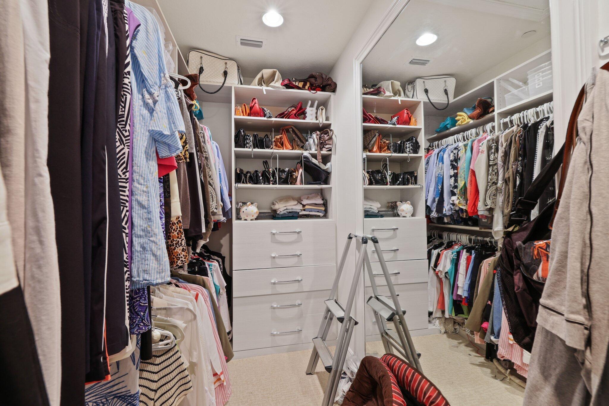 5530 Northeast Trieste Terrace, Unit 5530 Boca Raton, FL 33487 - Photo 44 of 57 a view of walk in closet with clothes and shoes