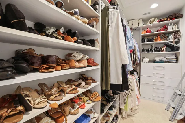 a bedroom with a bed and a dresser next to a window