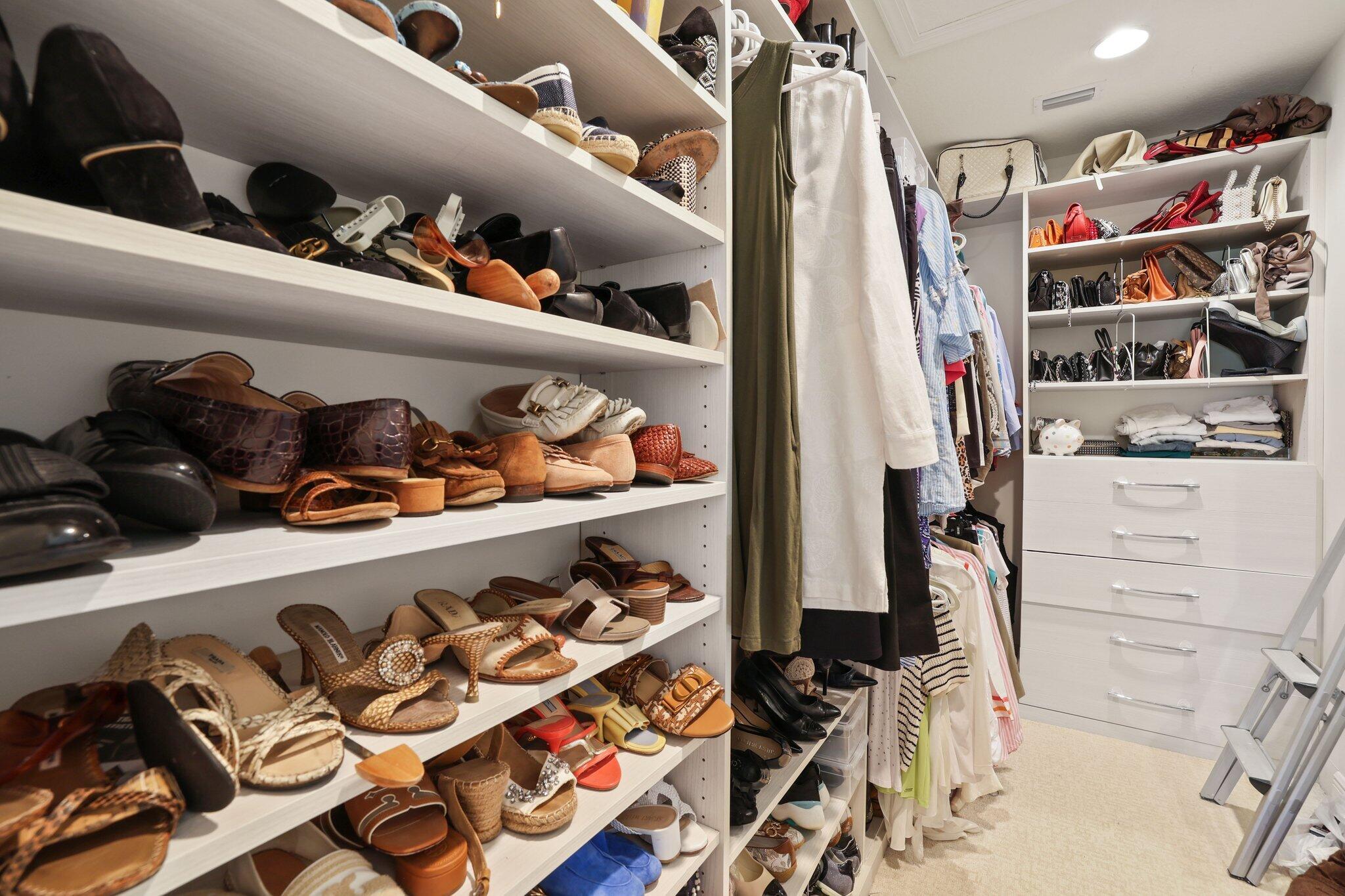 5530 Northeast Trieste Terrace, Unit 5530 Boca Raton, FL 33487 - Photo 45 of 57 a view of walk in closet with clothes and shoes