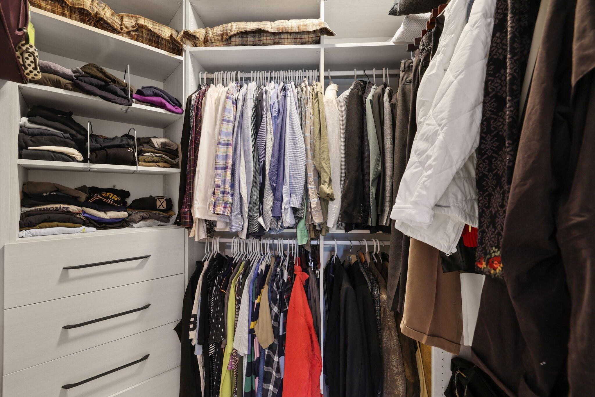5530 Northeast Trieste Terrace, Unit 5530 Boca Raton, FL 33487 - Photo 46 of 57 a view of walk in closet with clothes and shoes