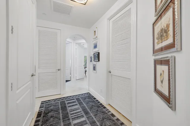 a view of swimming pool with outdoor seating and palm trees