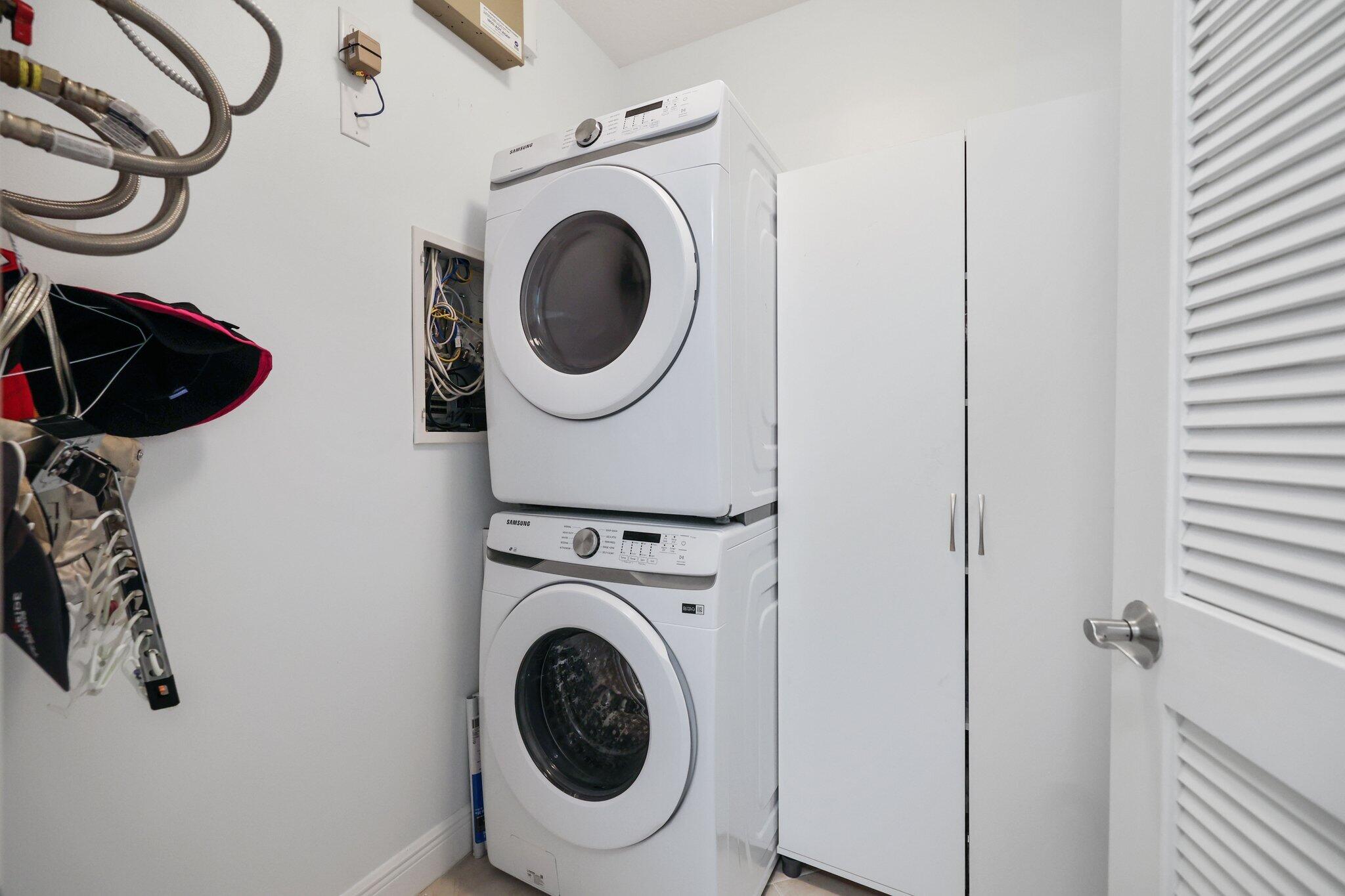 5530 Northeast Trieste Terrace, Unit 5530 Boca Raton, FL 33487 - Photo 50 of 57 a view of a hallway with washer and dryer