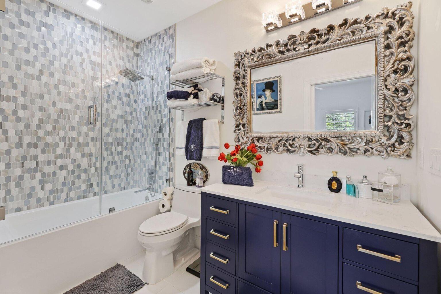 5530 Northeast Trieste Terrace, Unit 5530 Boca Raton, FL 33487 - Photo 51 of 57 a bathroom with a sink toilet and shower