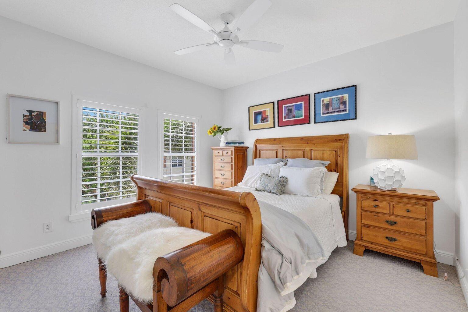 5530 Northeast Trieste Terrace, Unit 5530 Boca Raton, FL 33487 - Photo 52 of 57 a bedroom with a bed and a dresser next to a window