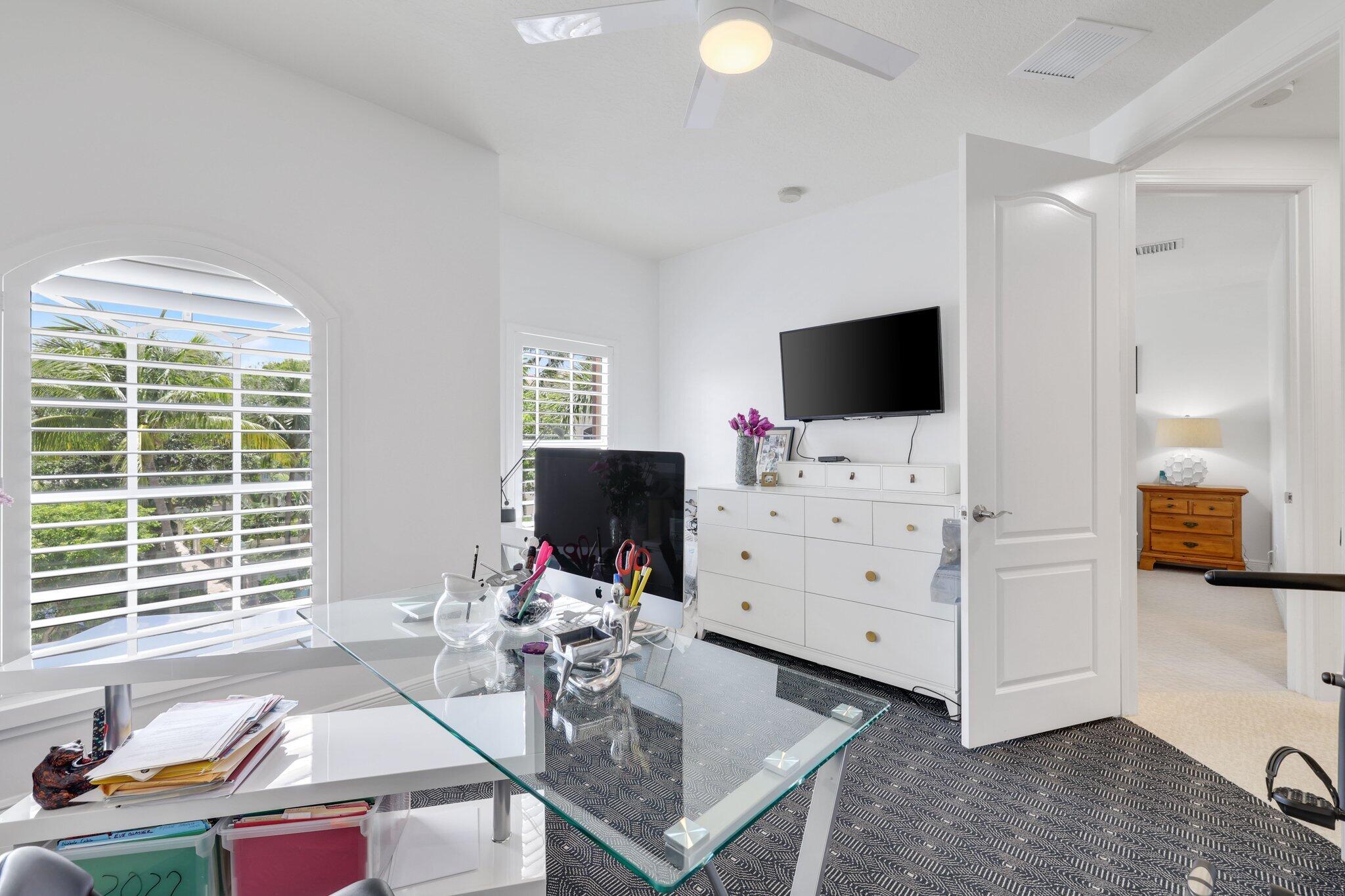5530 Northeast Trieste Terrace, Unit 5530 Boca Raton, FL 33487 - Photo 53 of 57 a living room with furniture and a flat screen tv