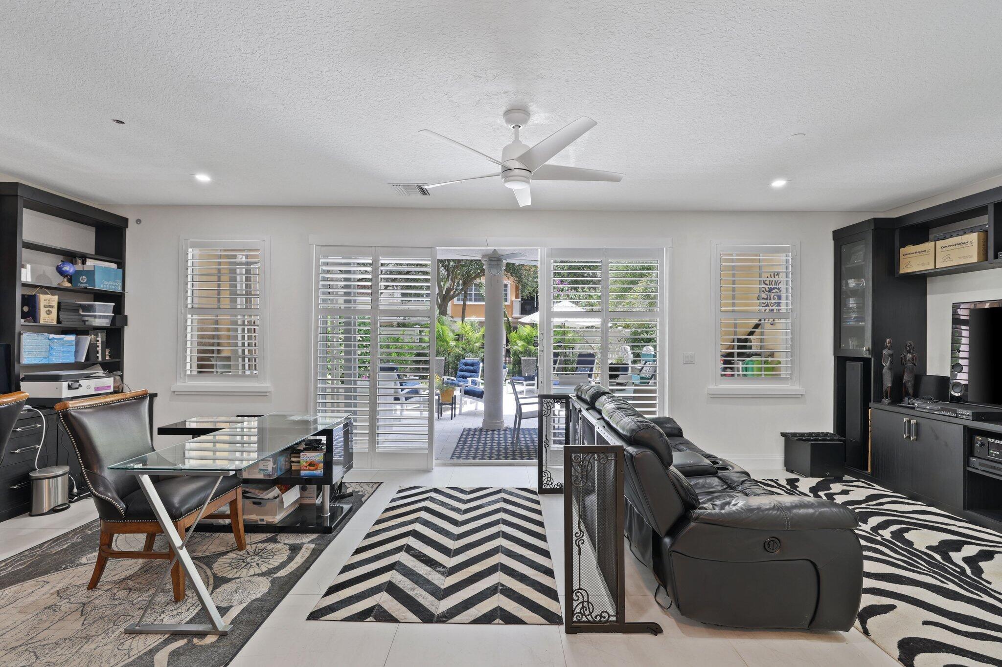 5530 Northeast Trieste Terrace, Unit 5530 Boca Raton, FL 33487 - Photo 9 of 57 a living room with furniture and a large window