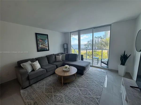 a living room with furniture and a large window