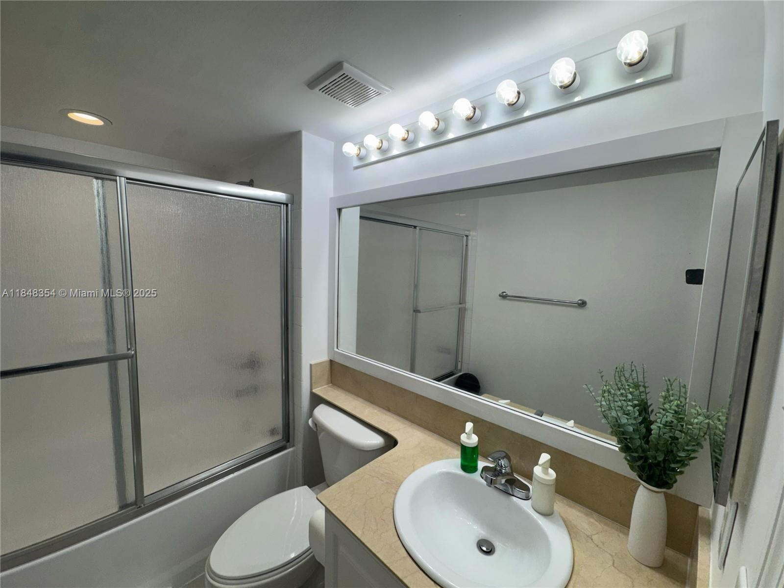 1155 Brickell Bay Drive, Unit 307 Miami, FL 33131 - Photo 17 of 23 a bathroom with a sink a toilet and shower
