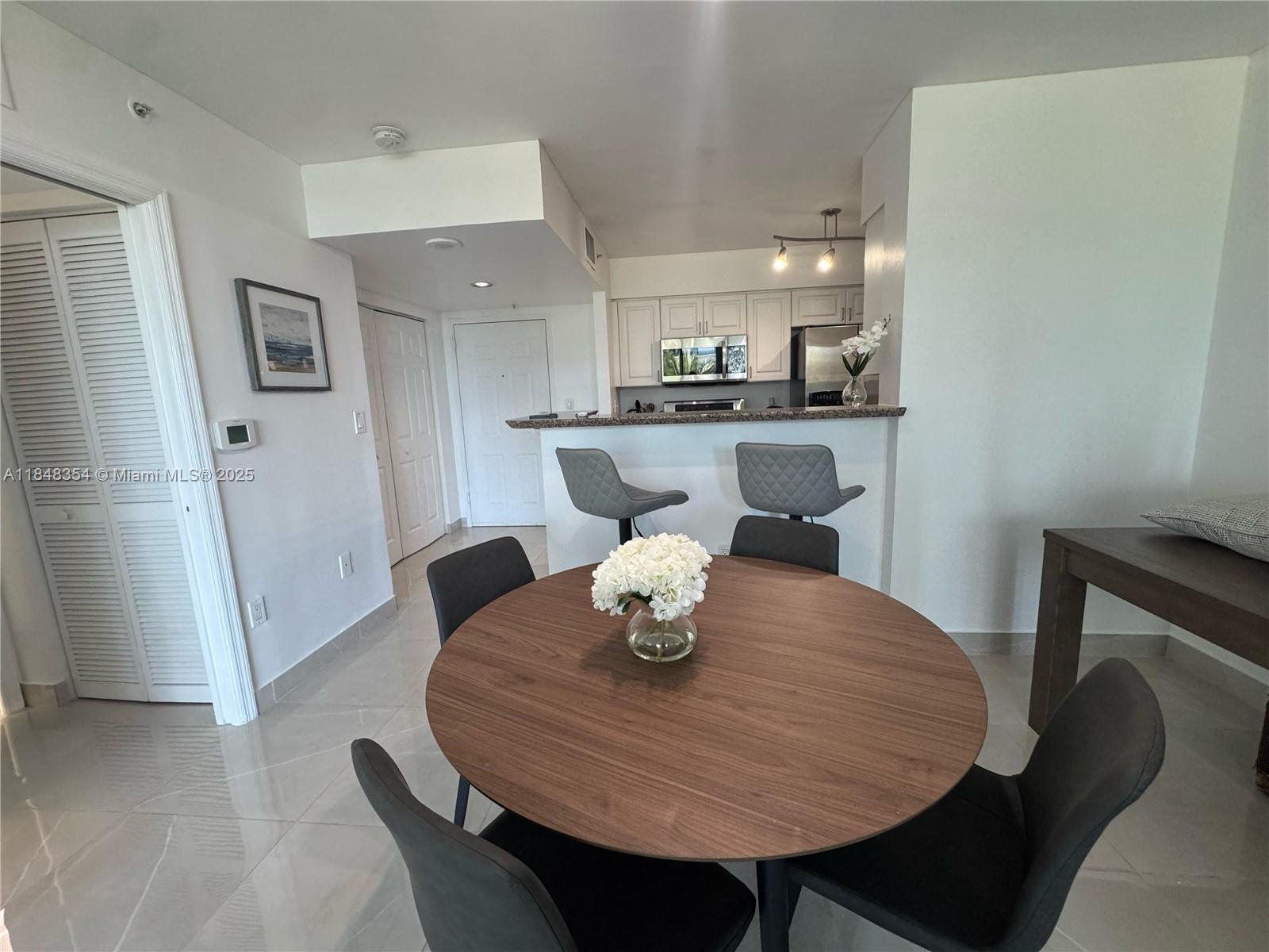 1155 Brickell Bay Drive, Unit 307 Miami, FL 33131 - Photo 8 of 23 a living room with furniture and a table