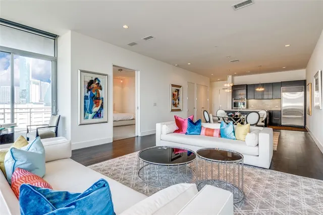 a living room with furniture and wooden floor