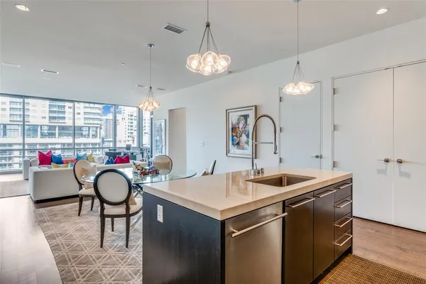 a kitchen with a sink and a chandelier