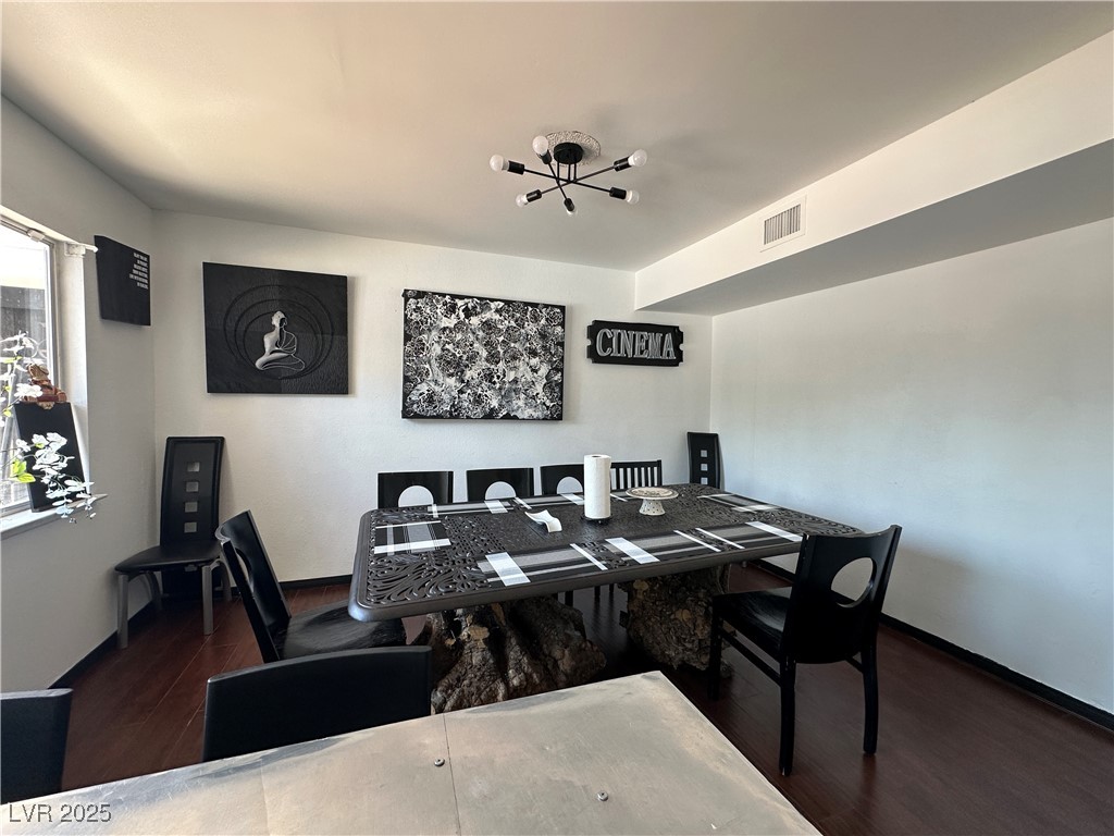 5929 West Cherokee Avenue Las Vegas, NV 89103 - Photo 10 of 30 Dining space with dark wood-style floors and a chandelier