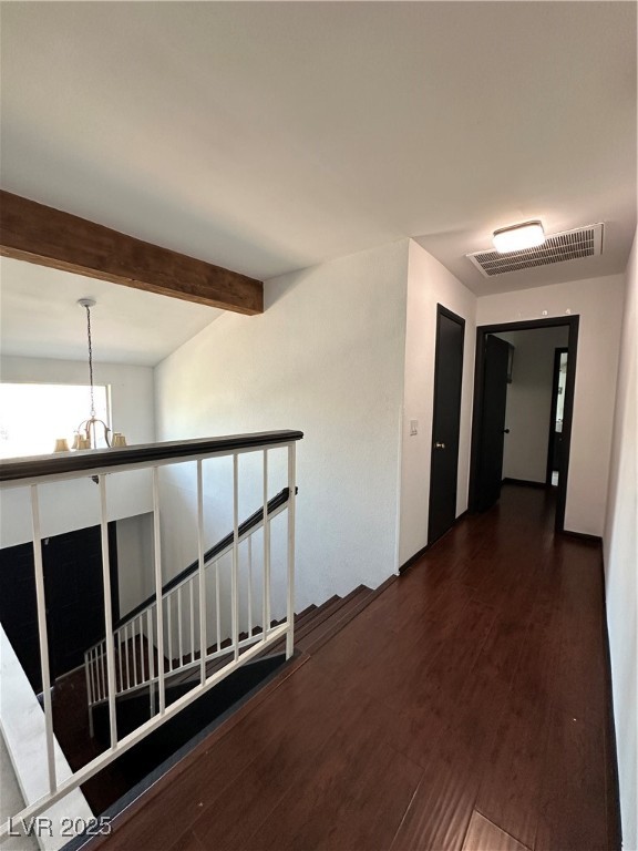 5929 West Cherokee Avenue Las Vegas, NV 89103 - Photo 14 of 30 Corridor featuring dark wood-style floors, a chandelier, and beam ceiling