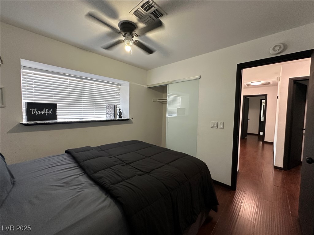 5929 West Cherokee Avenue Las Vegas, NV 89103 - Photo 16 of 30 Bedroom featuring dark wood finished floors, ceiling fan, and a closet