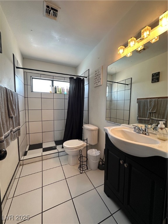 5929 West Cherokee Avenue Las Vegas, NV 89103 - Photo 19 of 30 Full bath featuring vanity, tiled shower, and light tile patterned floors
