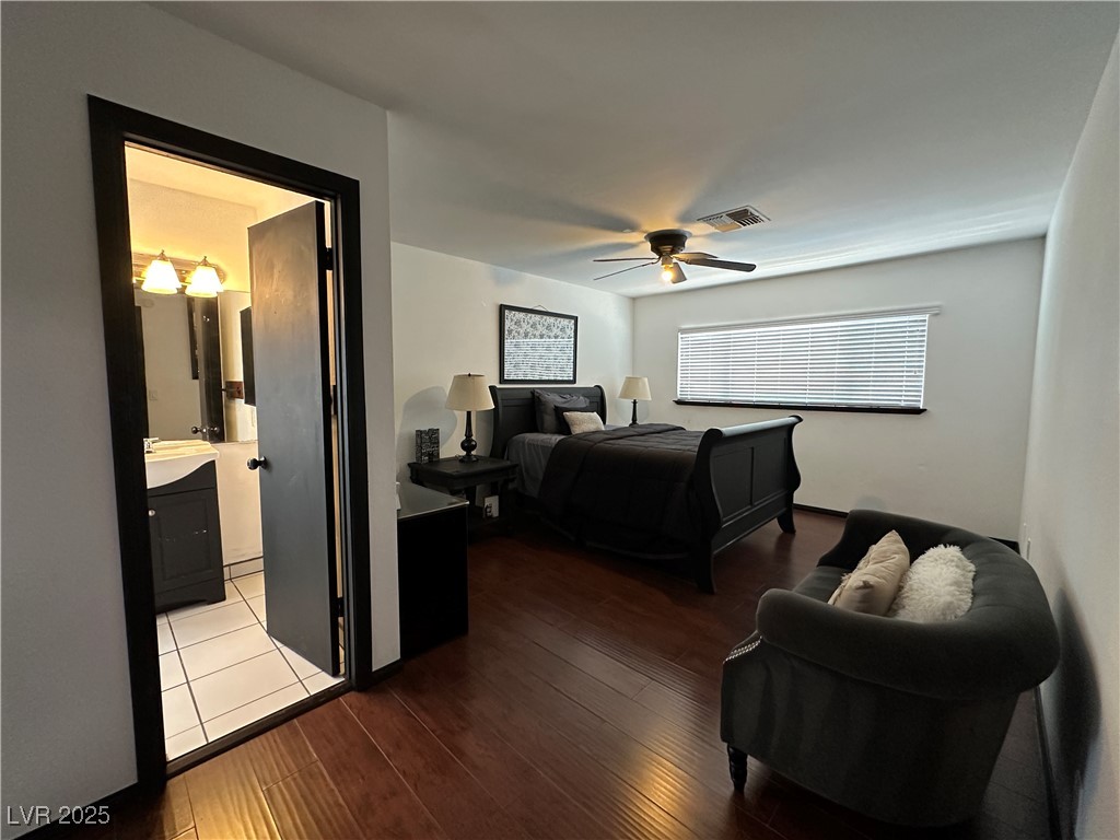 5929 West Cherokee Avenue Las Vegas, NV 89103 - Photo 22 of 30 Bedroom with hardwood / wood-style flooring, ceiling fan, and connected bathroom