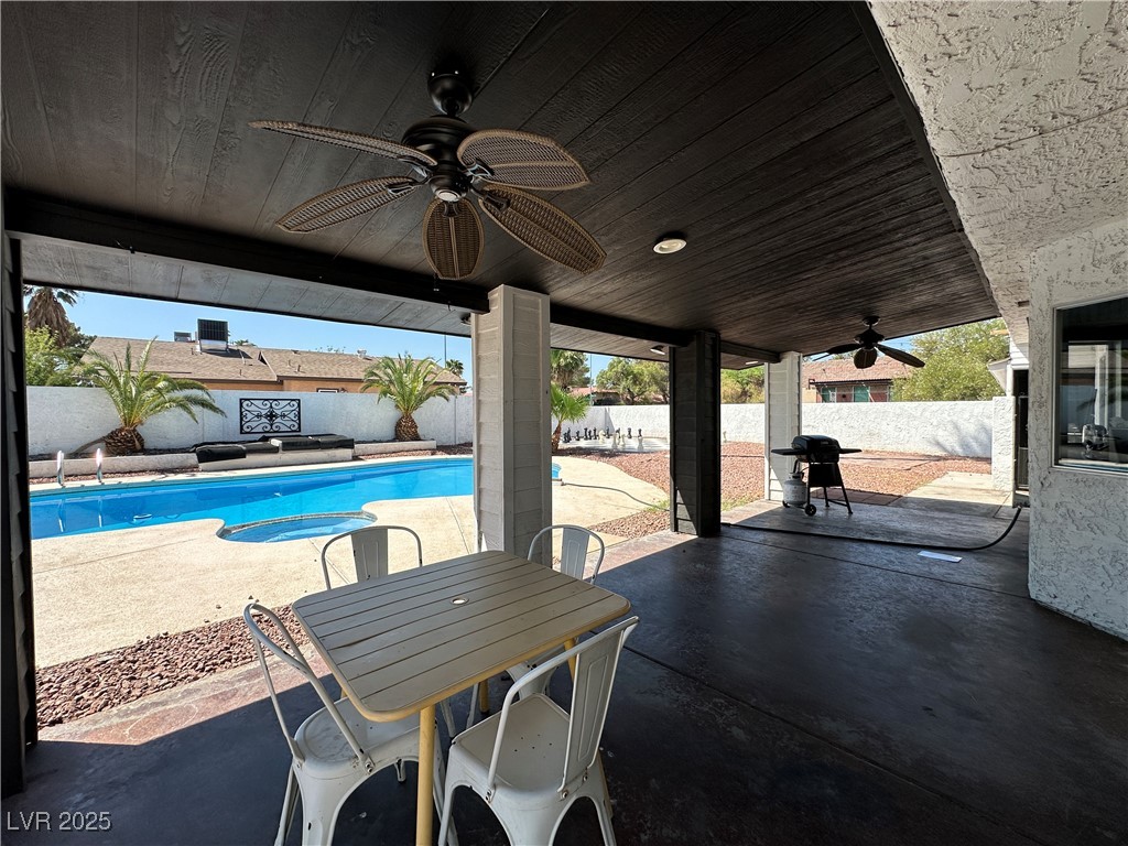 5929 West Cherokee Avenue Las Vegas, NV 89103 - Photo 26 of 30 Fenced backyard featuring a ceiling fan, a patio area, and grilling area