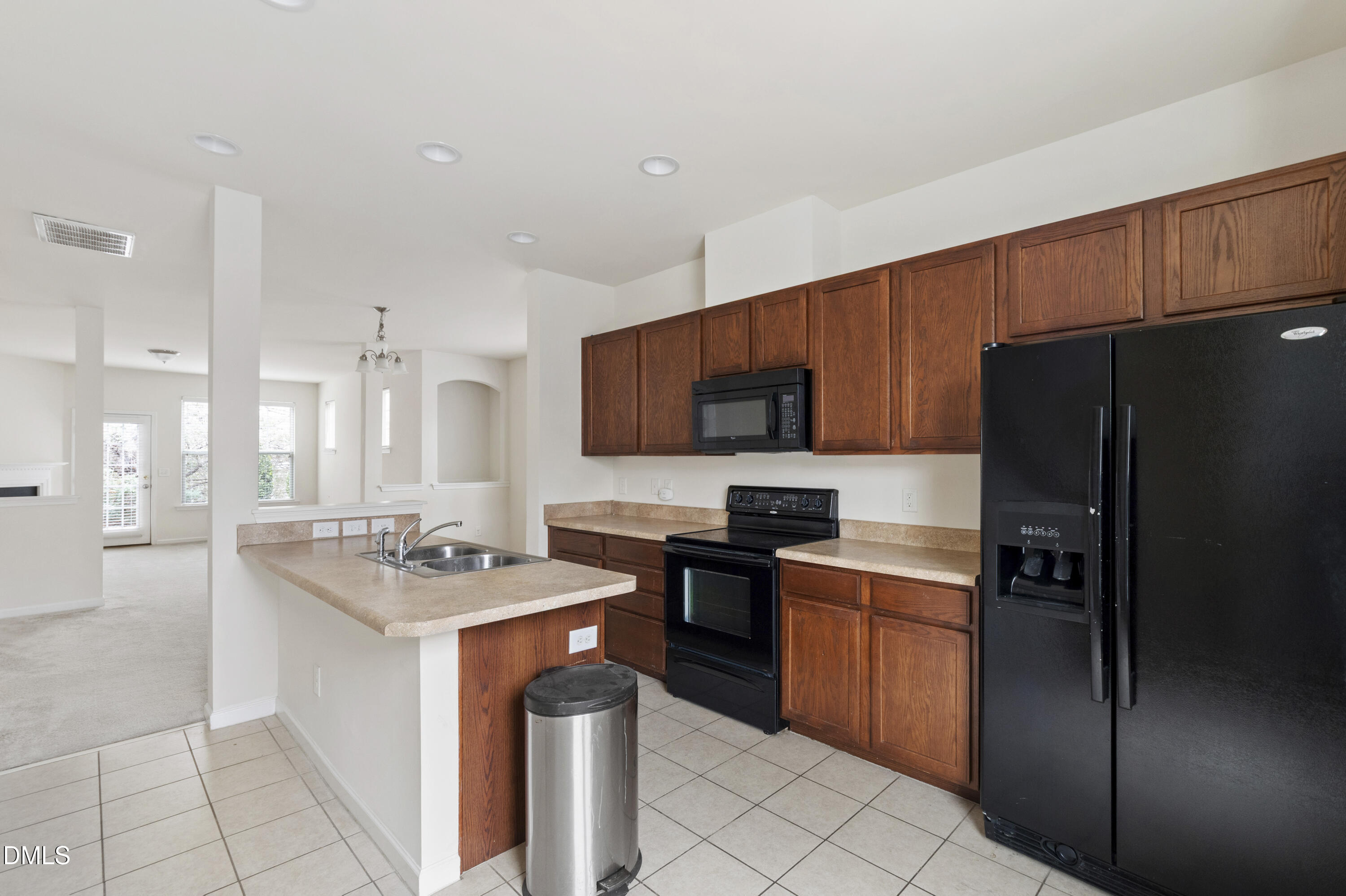 6617 Clarksburg Place Raleigh, NC 27616 - Photo 11 of 30 a kitchen with stainless steel appliances granite countertop a refrigerator stove microwave and sink