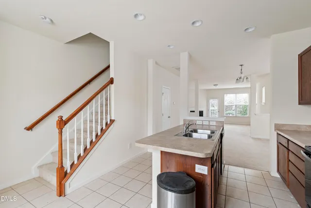 a kitchen with stainless steel appliances granite countertop a sink stove and microwave
