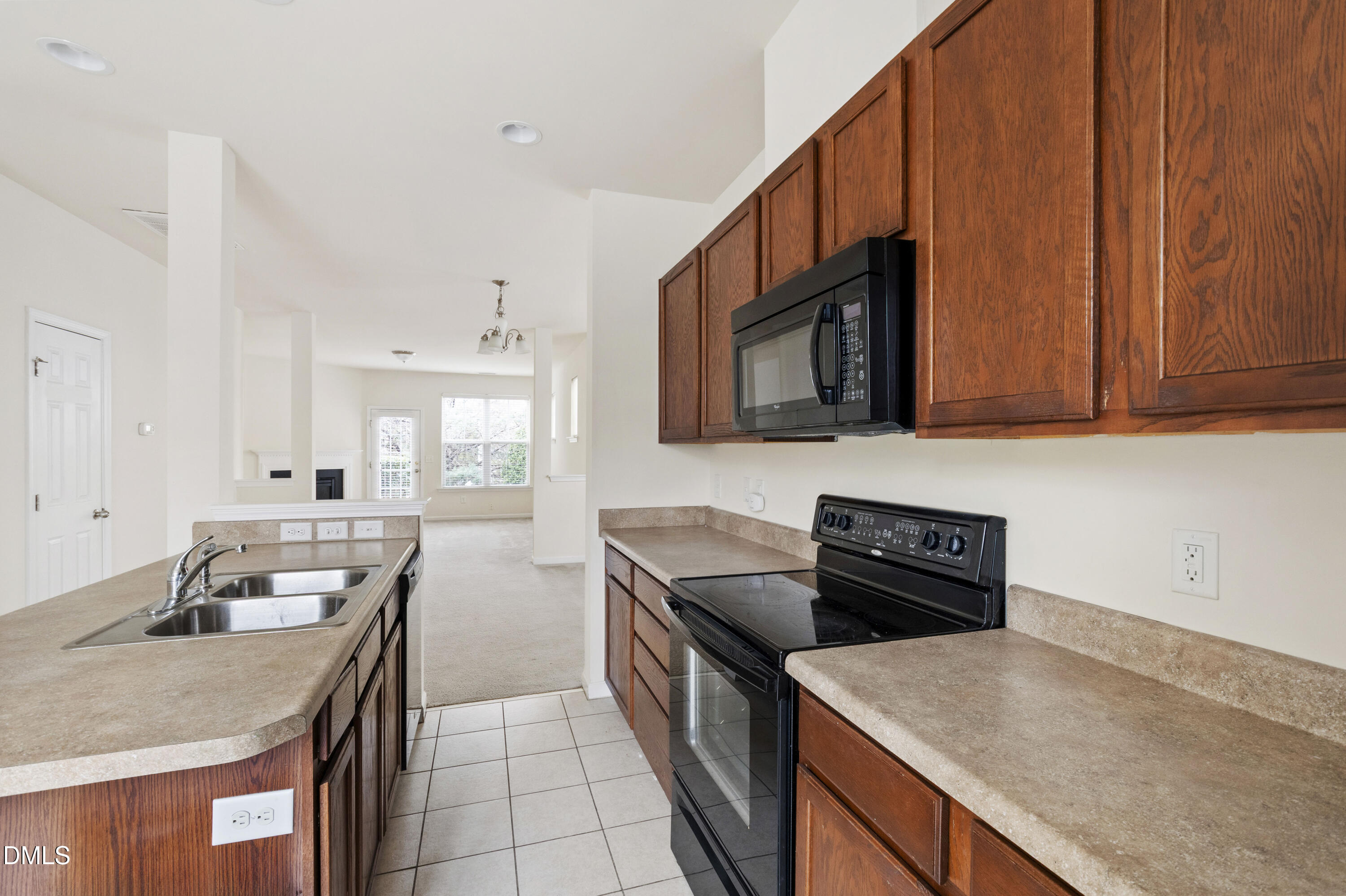 6617 Clarksburg Place Raleigh, NC 27616 - Photo 13 of 30 a kitchen with stainless steel appliances granite countertop a sink stove and microwave