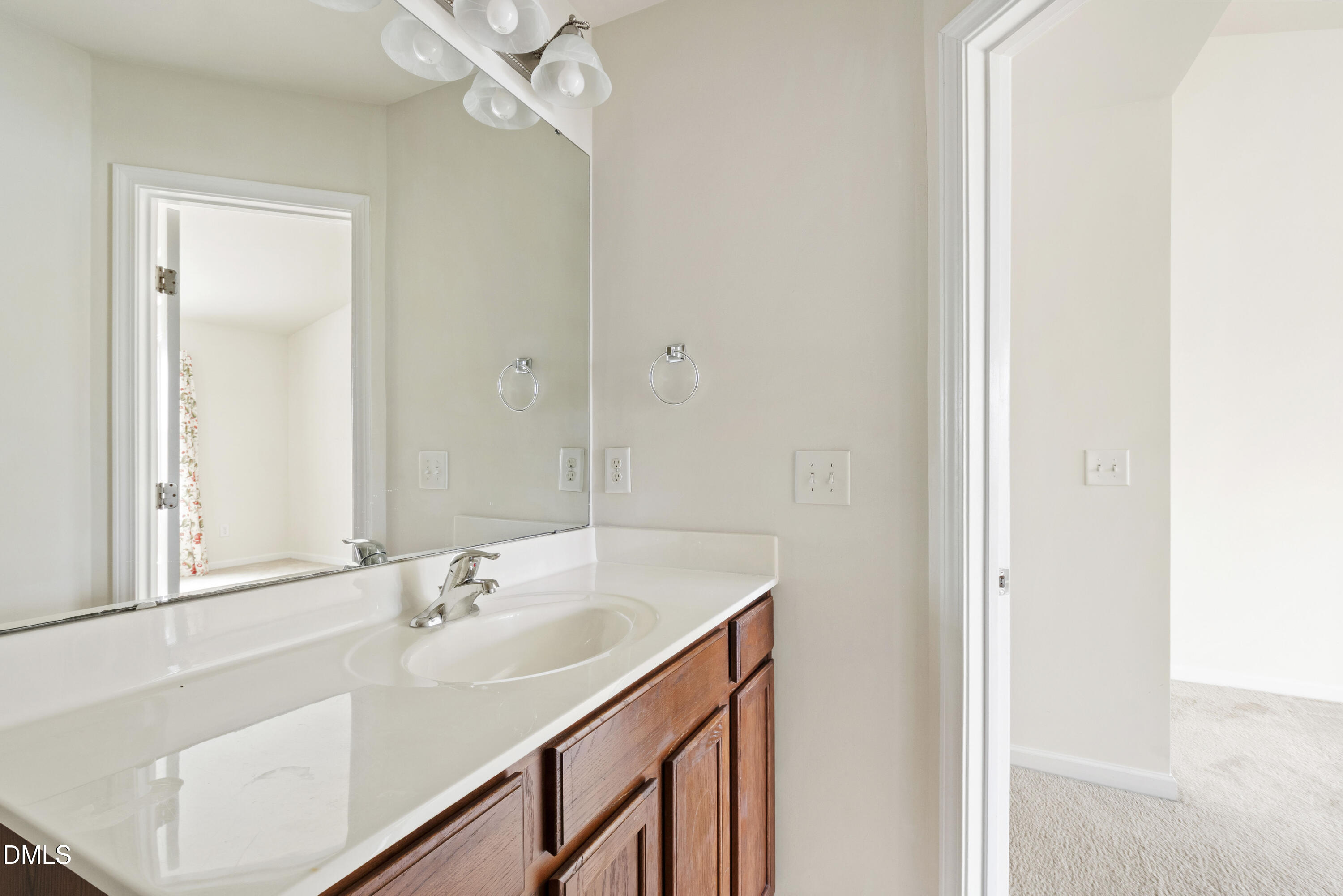 6617 Clarksburg Place Raleigh, NC 27616 - Photo 27 of 30 a bathroom with a sink vanity and a mirror