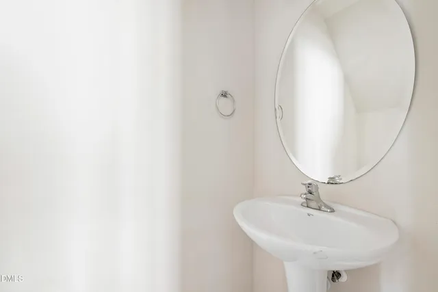 a kitchen with stainless steel appliances a refrigerator a stove a sink cabinets and a dining table