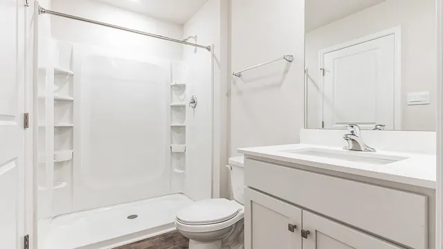 a bathroom with a sink toilet and shower