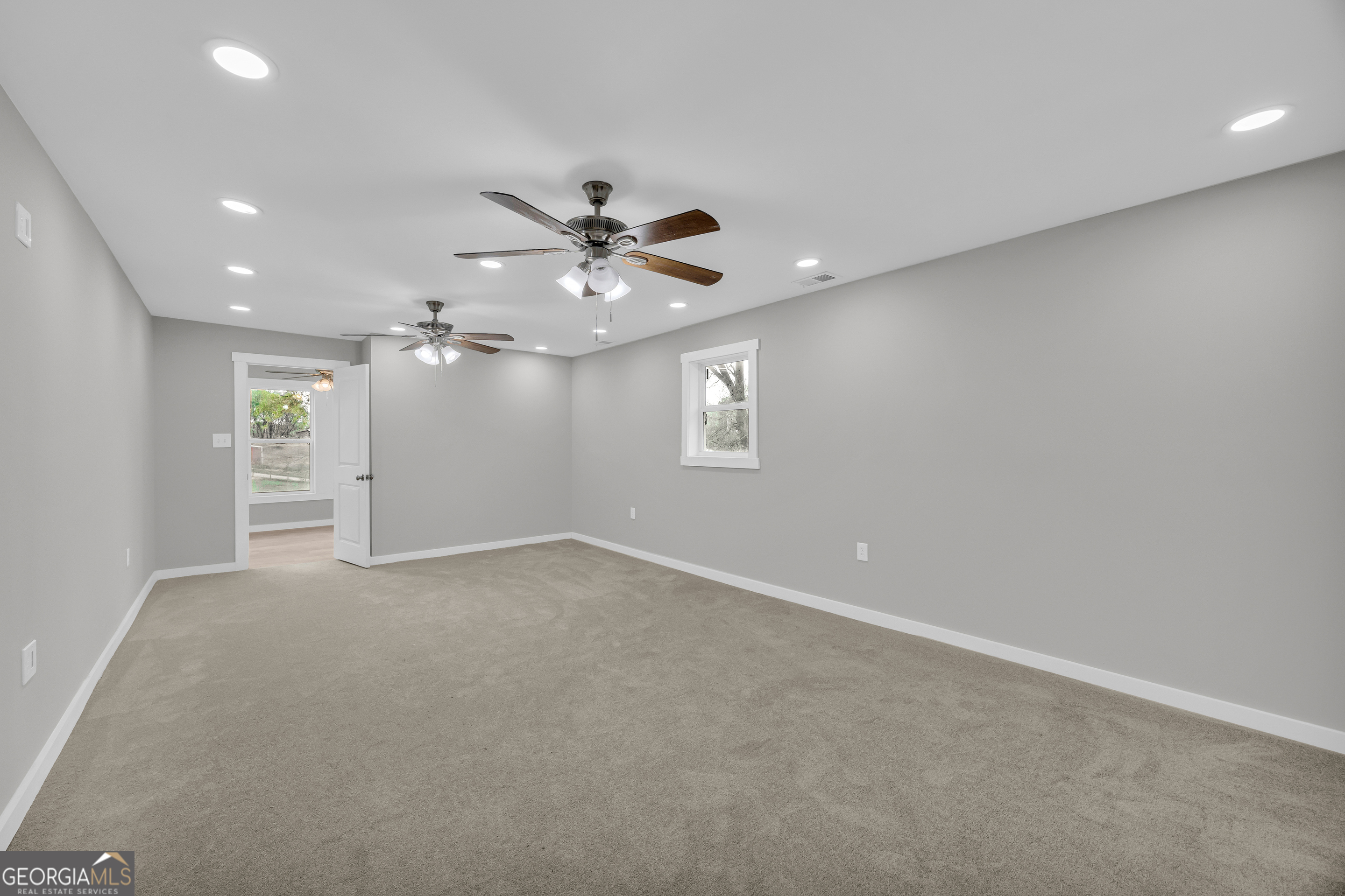 8606 Holly Springs Road Maysville, GA 30558 - Photo 50 of 74 wooden floor in an empty room with a window