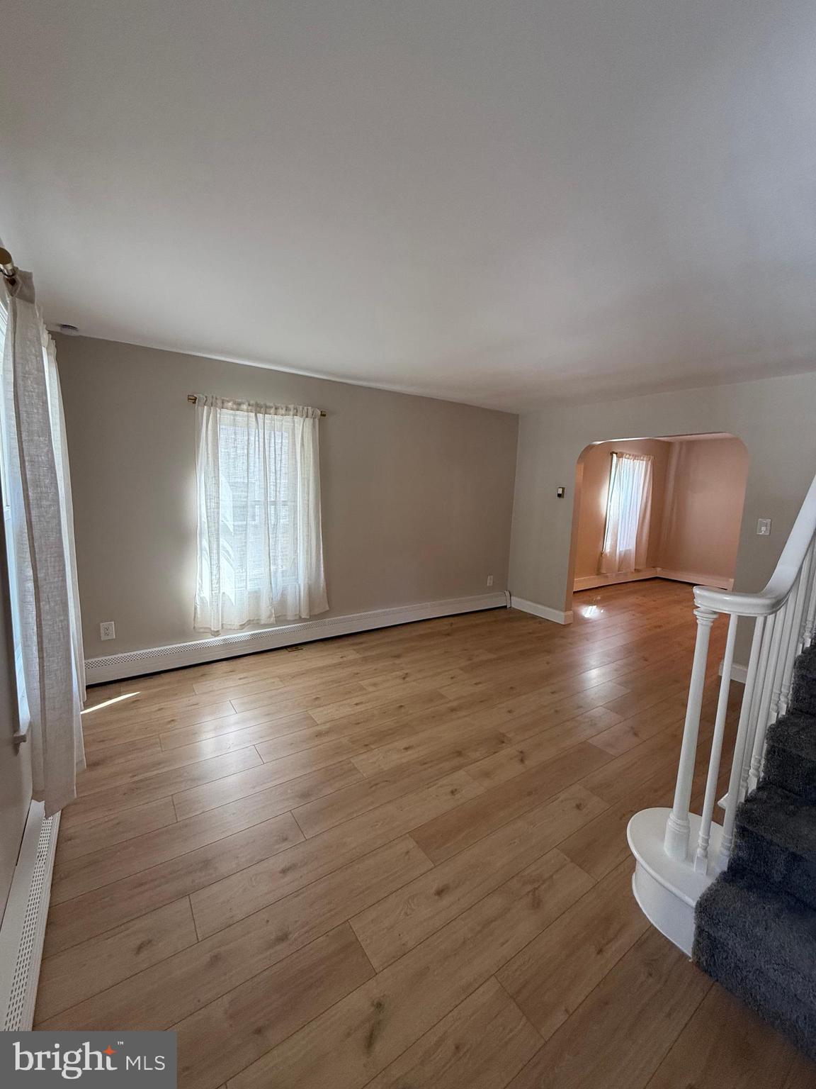 241 Fairview Road Crum Lynne, PA 19022 - Photo 5 of 34 an empty room with wooden floor fan and windows