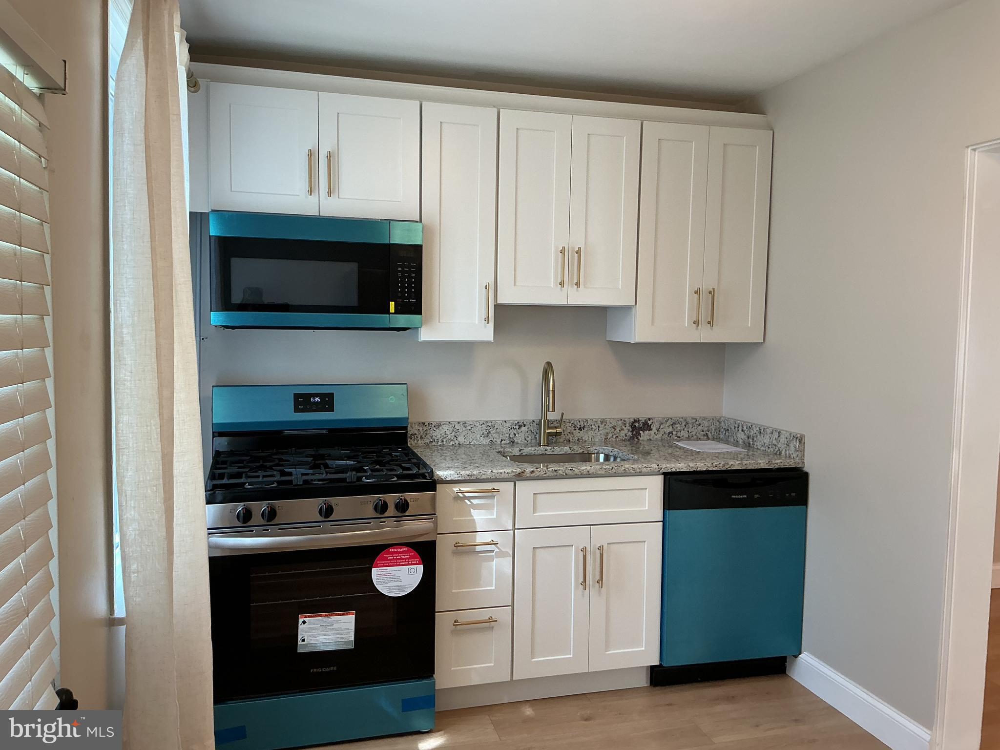 241 Fairview Road Crum Lynne, PA 19022 - Photo 8 of 34 a kitchen with stainless steel appliances granite countertop white cabinets and a stove