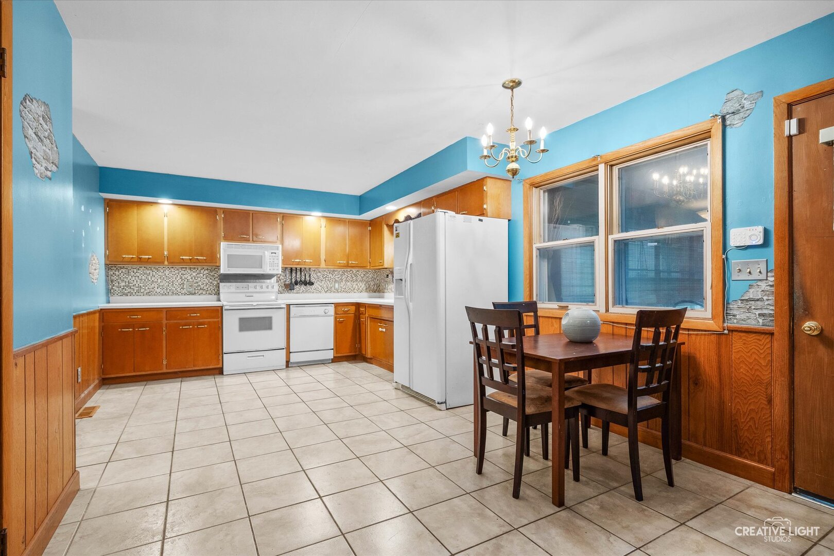 754 Haish Boulevard DeKalb, IL 60115 - Photo 6 of 20 a kitchen with a sink dining table and chairs