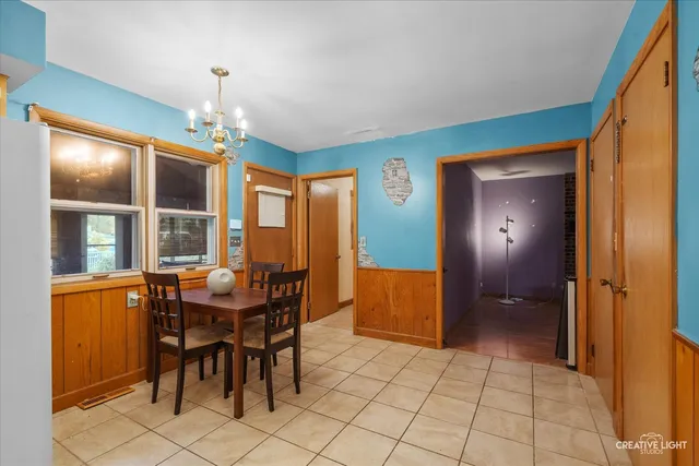 a view of a dining room with furniture and chandelier