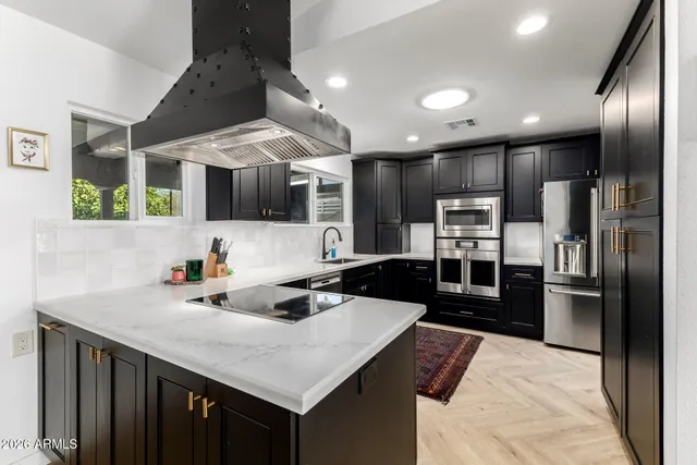 a kitchen with a refrigerator and a sink