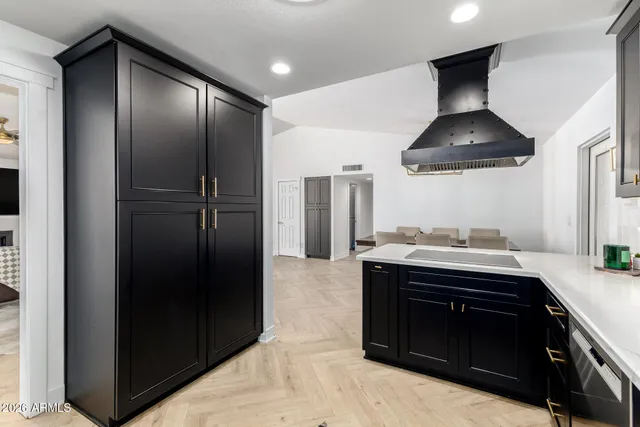 a kitchen with stainless steel appliances granite countertop a sink and a stove