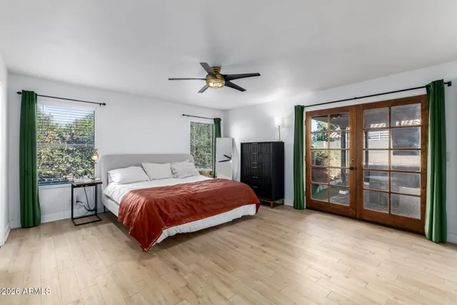 a bedroom with a large bed and a chandelier
