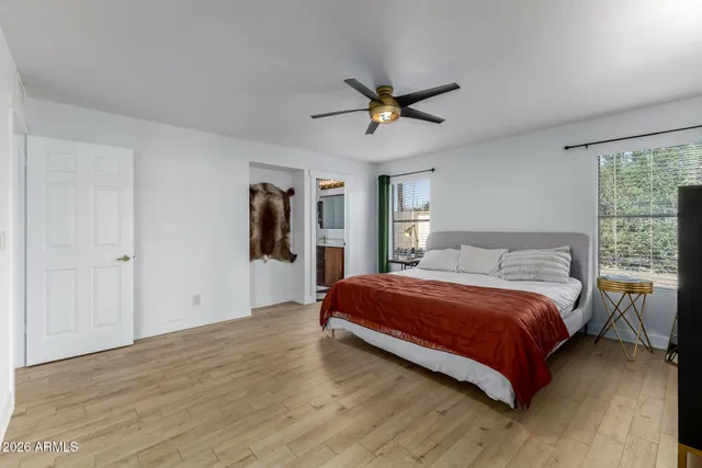 a bedroom with a large bed and a window