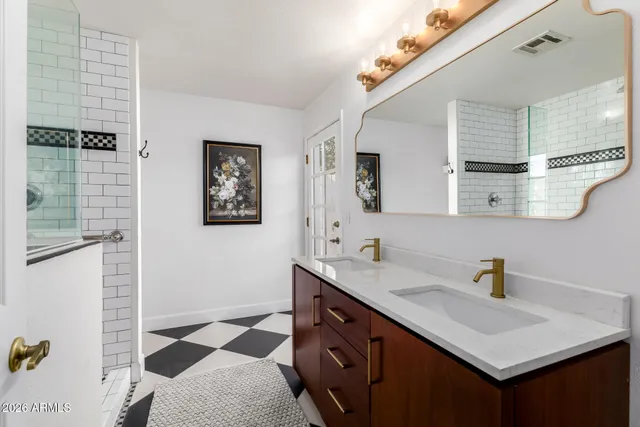 a bathroom with a sink and mirror