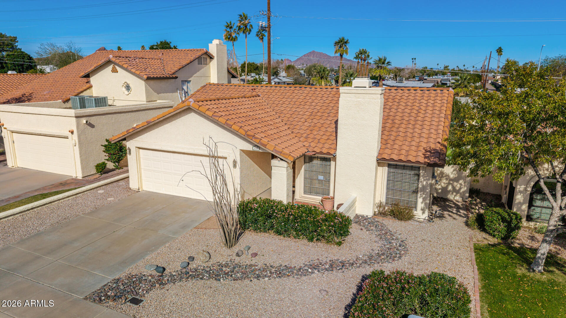436 East Bluebell Lane Tempe, AZ 85288 - Photo 43 of 59 a view of a white house with a yard and potted plants