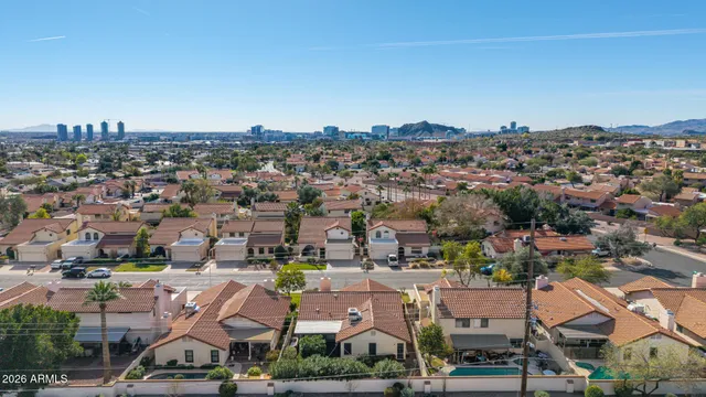 an aerial view of a house with a yard and potted plants
