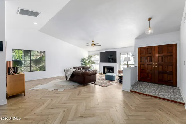 a living room with furniture a fireplace and a flat screen tv