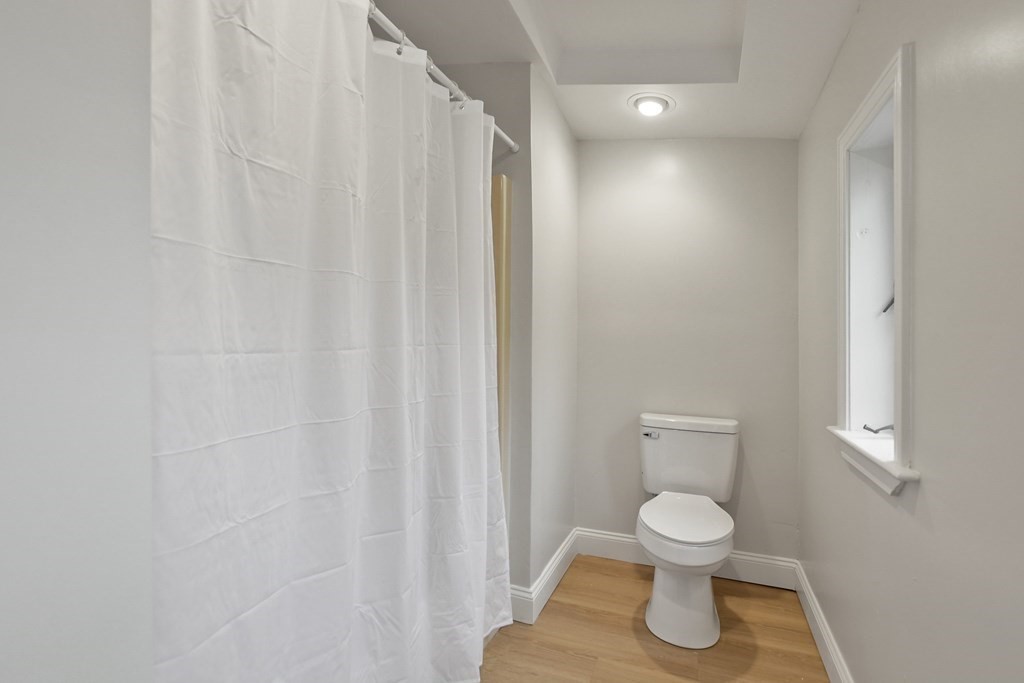 90 Manning Street Hudson, MA 01749 - Photo 14 of 33 a white toilet sitting next to a shower