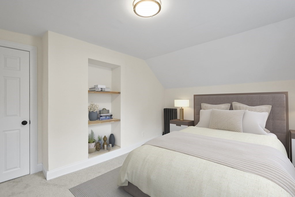 90 Manning Street Hudson, MA 01749 - Photo 16 of 33 a bedroom with a bed and a book shelf
