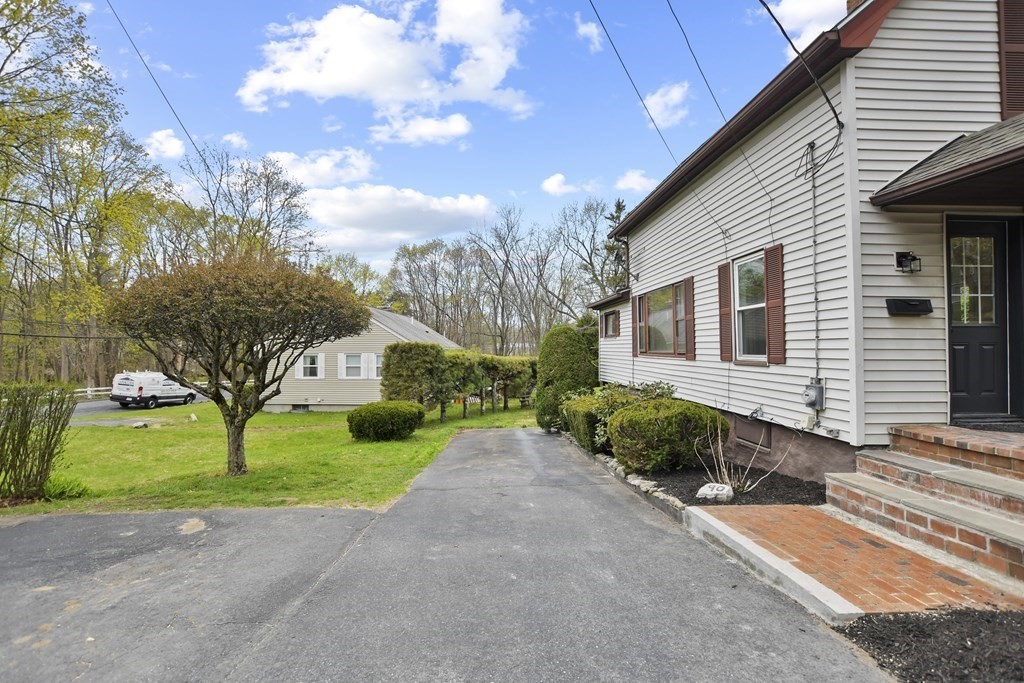 90 Manning Street Hudson, MA 01749 - Photo 27 of 33 a front view of a house with a yard and garage