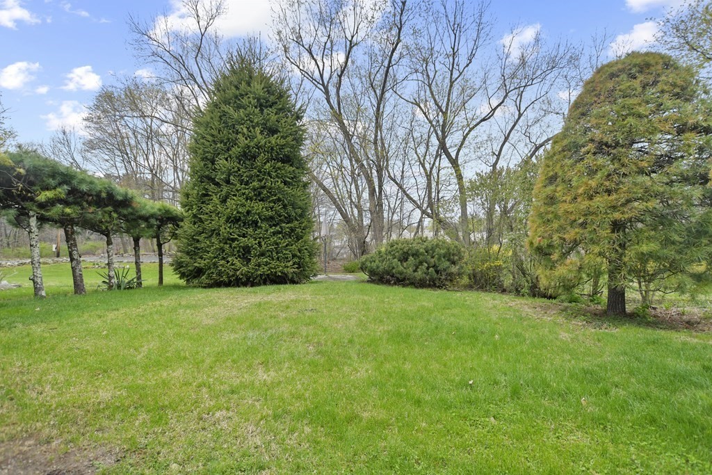 90 Manning Street Hudson, MA 01749 - Photo 33 of 33 a view of a grassy field with trees in the background