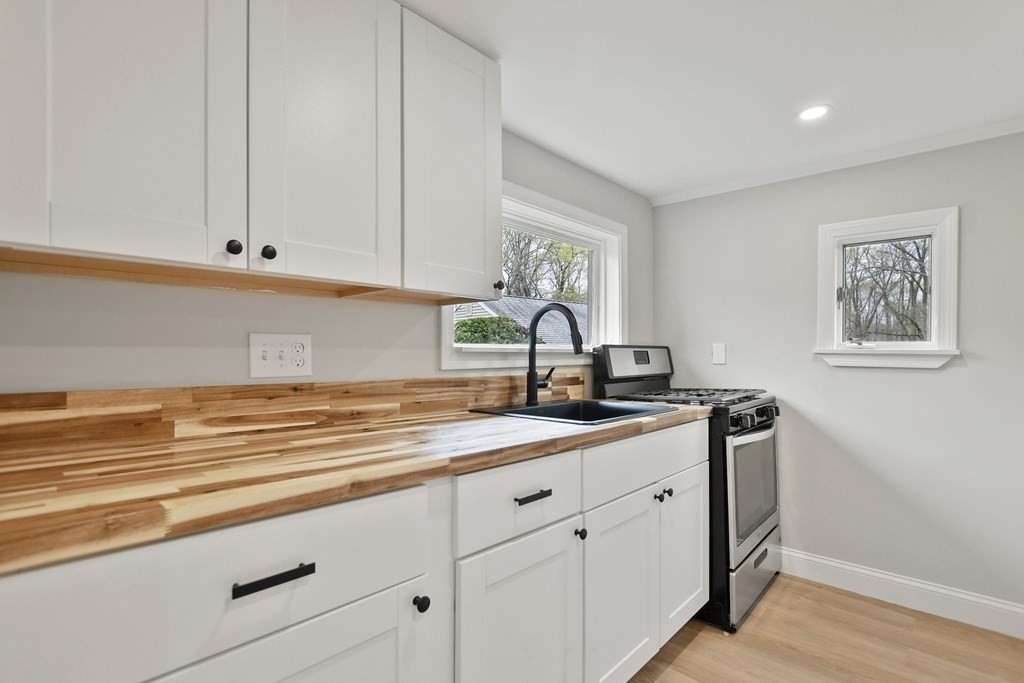 90 Manning Street Hudson, MA 01749 - Photo 6 of 33 a kitchen with granite countertop white cabinets and a sink