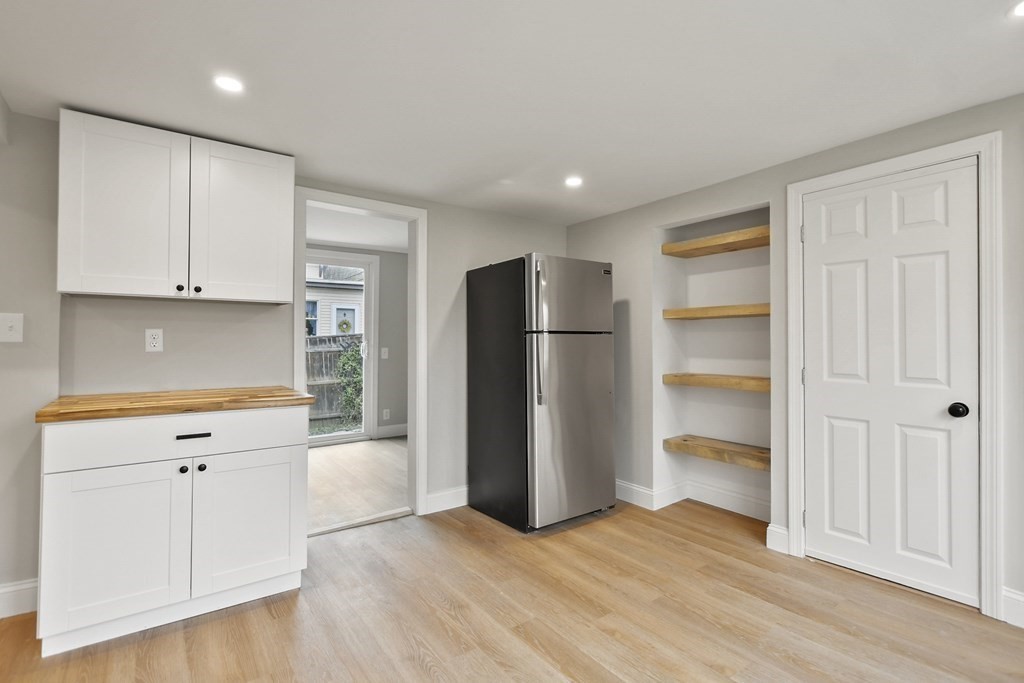 90 Manning Street Hudson, MA 01749 - Photo 7 of 33 a view of a kitchen with refrigerator and cabinets